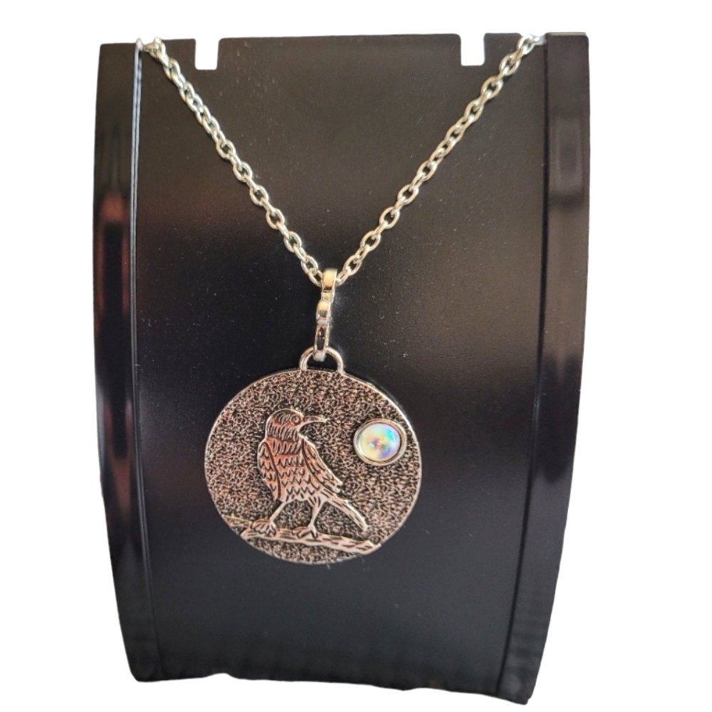 Vintage style necklace silver tone with an 18-20" chain. Pendant has bird & moon